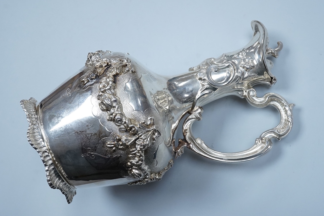 A continental white metal (stamped 0.925) ewer, decorated with floral garlands, height 28cm, 25.4oz.